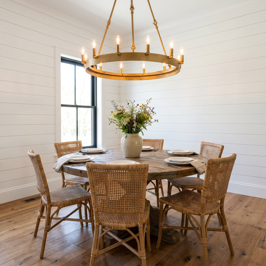 Camino one-tier wagon wheel brass chandelier above a round farmhouse dining table