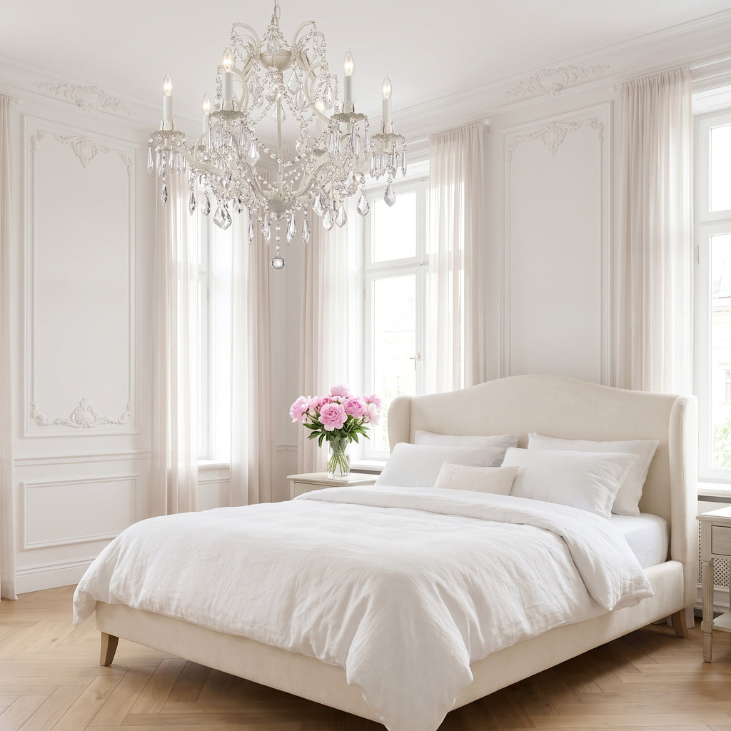 White wrought iron crystal chandelier in a bright elegant white bedroom