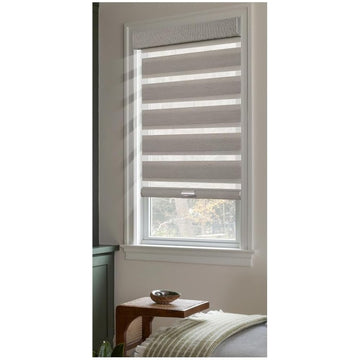 Grey linen zebra blind half open on a bedroom window